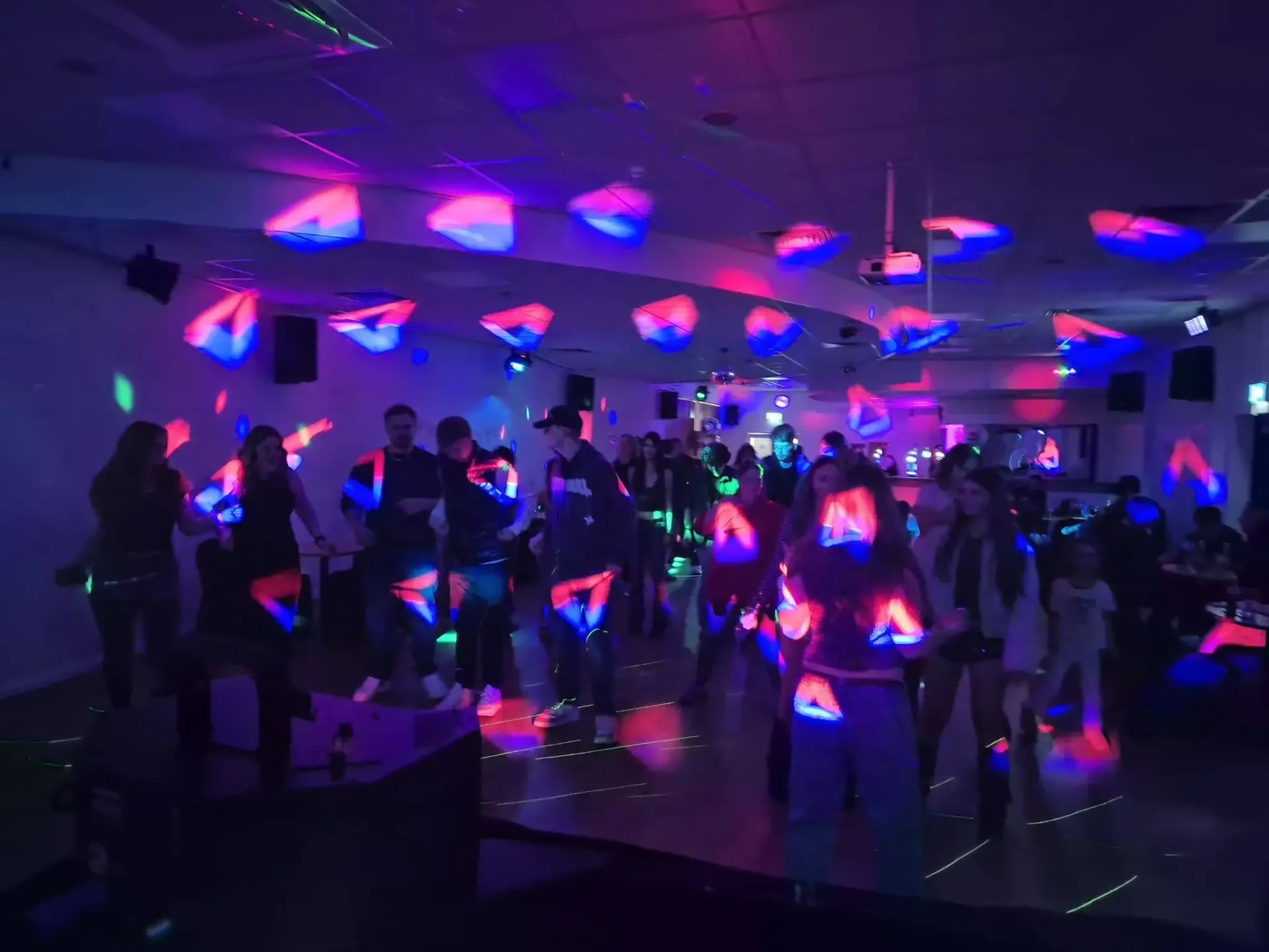 Packed dance floor with full lighting rig